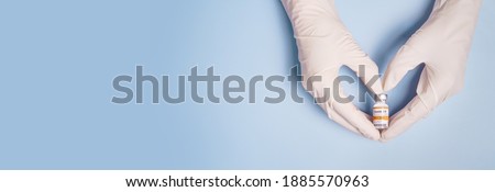 Doctor Hands in protective gloves holding Coronavirus 2019-nCoV Vaccine vial and gesture in heart shape. Successful, Hope, Good news, Support, Donation, Priority, Fight with Covid-19 pandemic. Banner.