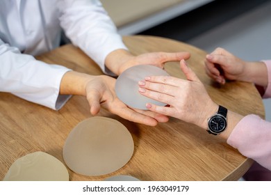 Doctor Hands Showing Patient New Medical Implants. Operating Plastic Procedure.