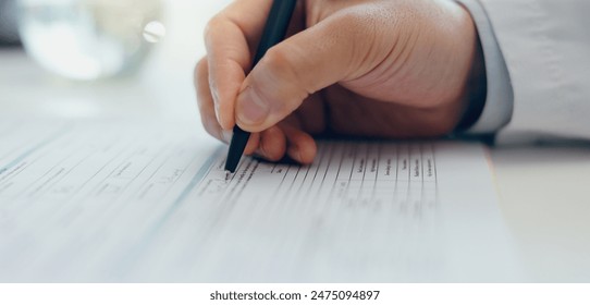 Doctor, hands or writing with document for signature, application or information on desk at hospital. Closeup of healthcare employee filling in form, paperwork or signing for medical aid or insurance - Powered by Shutterstock