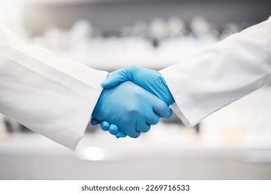 Doctor, handshake and gloves for healthcare, partnership or trust for collaboration, unity or lab support at. Team of medical experts shaking hands in teamwork for agreement or research success - Powered by Shutterstock