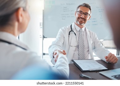 Doctor Handshake, Medical Welcome And Man Consulting With Team For Healthcare Planning At Hospital. Mature Employee Working In Medicine Meeting A Consultant For Collaboration And Help At Clinic