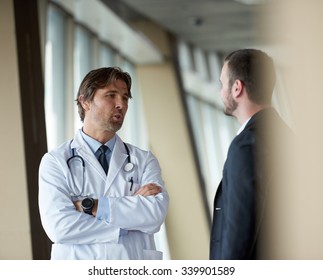 doctor handshake with a patient at doctors bright modern office in hospital