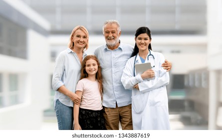 Doctor With Happy Family Of Mother, Father And Daughter At The Hospital. Medical Healthcare And Doctor Service.