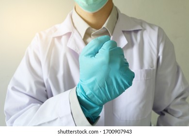 Doctor Or Health Professional Wearing Medical Grove. Hand Wearing Gloves. Medical Gloves. Surgical Glove. Hand With A Fist For Fighting Covid-19 Or Coronavirus. Medical Gloves. Surgical Glove.