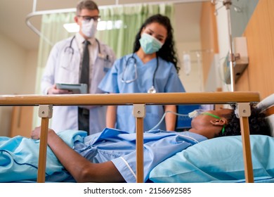 Doctor And Healthcare Staff Take Care Patient With Emergency Outcome In Room And They Also Wearing Hygiene Mask Try To Treatment Patient To Get Good Result.