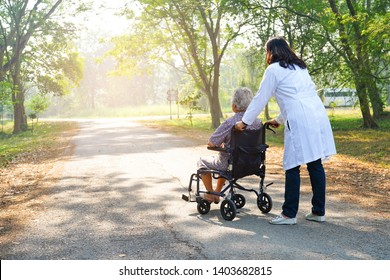Doctor help and care Asian senior or elderly old lady woman patient sitting on wheelchair at nursing hospital ward : healthy strong medical concept 
