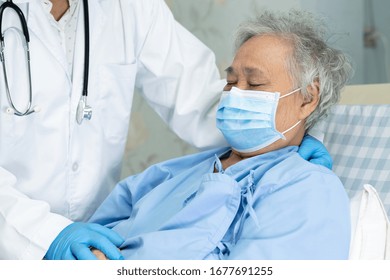 Doctor Help And Care Asian Senior Or Elderly Old Lady Woman Patient Wearing A Face Mask In Hospital For Protect Infection And Kill Novel Coronavirus (2019-nCoV) Covid-19 Virus.