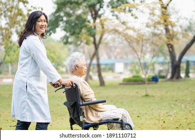 Doctor help and care Asian senior or elderly old lady woman patient sitting on wheelchair at park in nursing hospital ward, healthy strong medical concept.