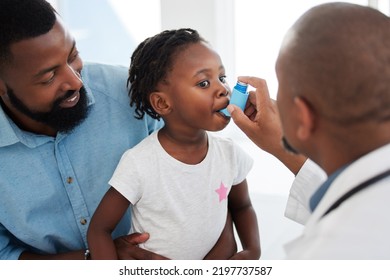 Doctor helping a child patient with an asthma inhaler in his office at the medical clinic. Healthcare worker consulting a girl with chest or respiratory problems with pump in a childrens hospital - Powered by Shutterstock