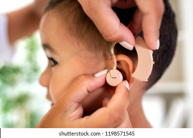 A Doctor Helping Little Child To Hear Sound Again Using Specialized Medical Device