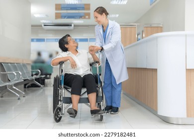 Doctor helping senior patient push wheelchair in hospital interior. - Powered by Shutterstock