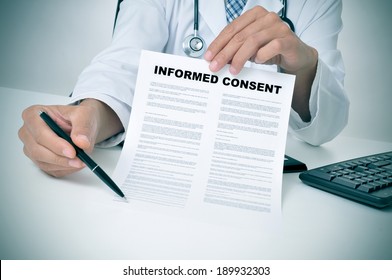 a doctor in his office showing an informed consent document and pointing with a pen where the patient must to sign - Shutterstock ID 189932303