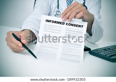 a doctor in his office showing an informed consent document and pointing with a pen where the patient must to sign