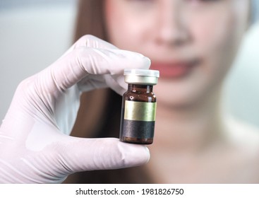 Doctor Hold Bottle  Of Liquid In Hand For Treating Woman ,filler, Botox At Beauty Clinic, Label Copy Space 