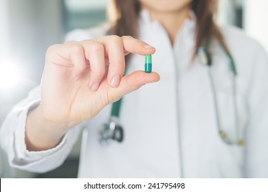 doctor hold a pill