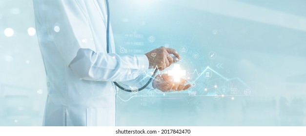 Doctor hold stethoscope on virtual medical network icons. Covid-19 pandemic develop people awareness and spread attention on healthcare, rising growth in hospital and health insurance business. - Shutterstock ID 2017842470