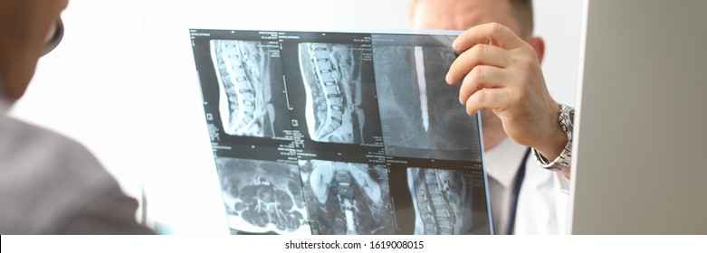 Doctor Hold Xray Bone Spine Radiography In Hand. Examination And Treatment Of Intervertebral Hernia. Traumatology Tomography Hospital Radiographer Concept.