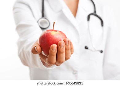 Doctor holding apple and recommending healthy lifestyle