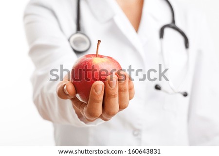Doctor holding apple and recommending healthy lifestyle
