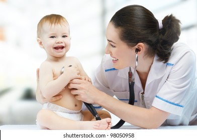 a doctor holding a baby on the hands