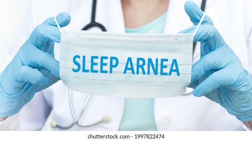 The Doctor Is Holding A Blue Disposable Mask With Inscription Sleep Apnea, Virus, Protection