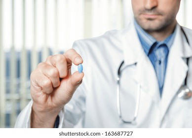 Doctor Holding A Blue Pill.