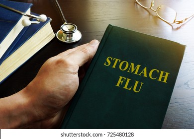 Doctor Holding Book About Stomach Flu.