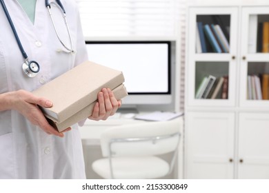 Doctor Holding Books Indoors, Closeup With Space For Text. Medical Education