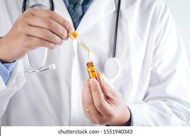 Doctor Holding A Bottle Of Hemp Oil, Medical Marijuana Products Including Cannabis Leaf,alternative Medicine,CBD Hemp Oil,