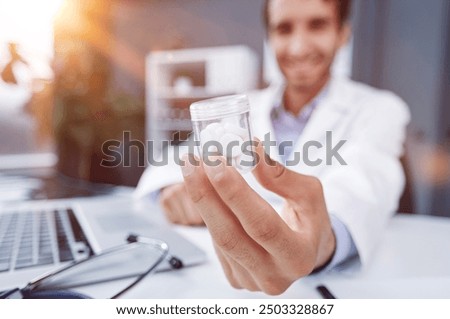 doctor holding bottle of pills. The concept of medicine, pharmacology, healthcare.