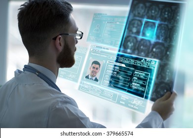 Doctor Holding Brain Mri And Examining It Using Virtual Future Technology