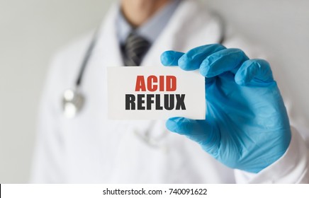 Doctor Holding A Card With Text Acid Reflux, Medical Concept