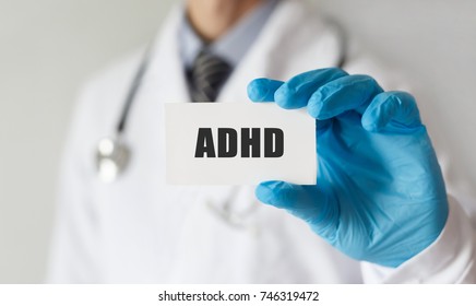 Doctor Holding A Card With Text ADHD, Medical Concept