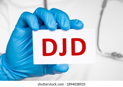 Doctor Holding A Card With Text DJD Degenerative Joint Disease, Medical Concept