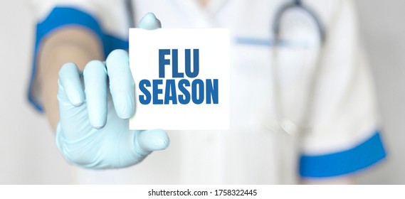 Doctor Holding A Card With Text Flu Season, Medical Concept