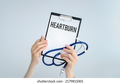 Doctor Holding A Card With Text HEARTBURN, Medical Concept.