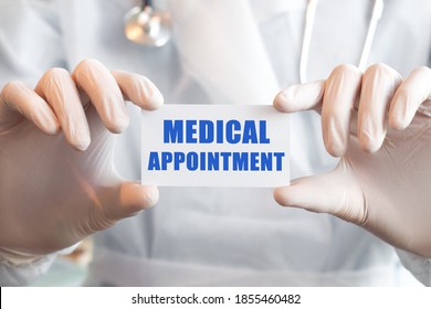 Doctor Holding A Card With Text MEDICAL APPOINTMENT In Both Hands. Medical Concept,