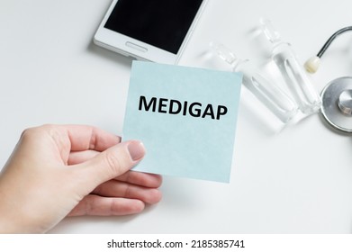 Doctor Holding A Card With Text Medigap,medical Concept