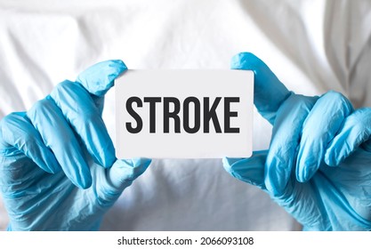 Doctor Holding A Card With Text Stroke, Medical Concept