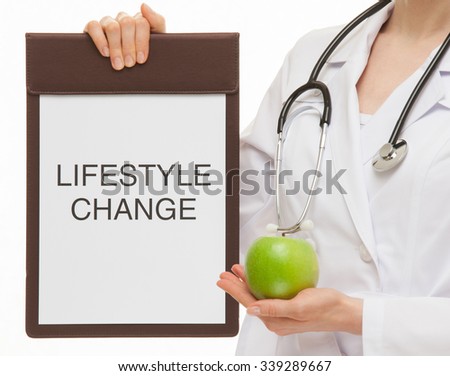 Doctor holding a clipboard and a green apple, white background