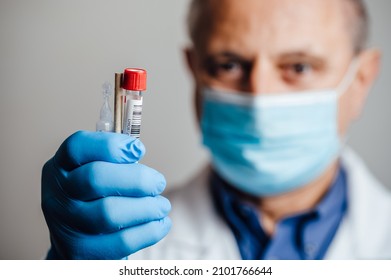 Doctor Holding Contents Of A Gargle PCR Test