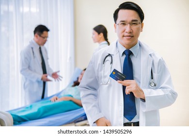 Doctor Holding Credit Cards In His Hand In Hospital