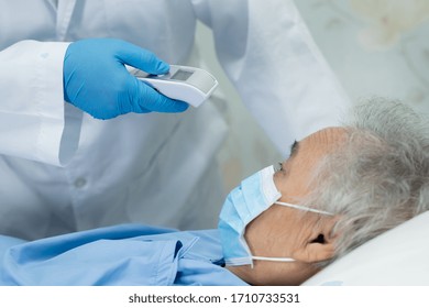 Doctor Holding Digital Thermometer To Measures Asian Senior Or Elderly Old Lady Woman Patient Wearing A Face Mask Have A Fever In Hospital : Healthy Strong Medical Concept.