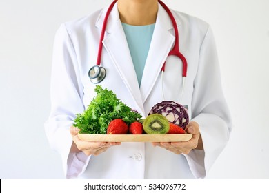 Doctor holding fresh fruit and vegetable, Healthy diet, Nutrition food as a prescription for good health. (Selective Focus) 