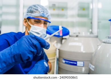 Doctor in the holding frozen egg in laboratory storage of the in vitro fertilization.