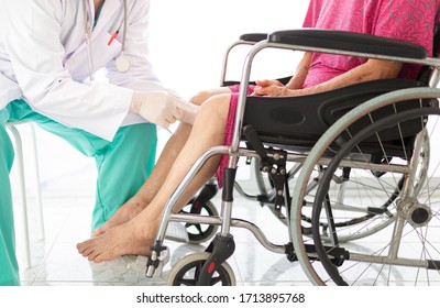 doctor holding leg of old stroke patient in hospital, elderly rehabilitation clinic, they training to rehab muscle, replacement of knee osteoarthritis