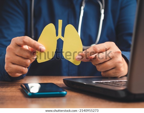 Doctor\
holding lungs symbol while sitting in the hospital. World\
tuberculosis day, world no tobacco day, lung cancer, pulmonary\
hypertension, pneumonia, COVID-19. Close-up\
photo