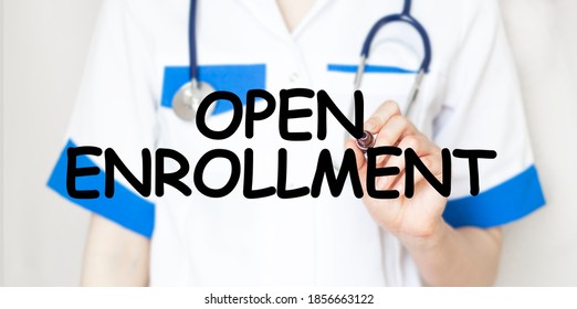 Doctor holding a marker with text OPEN ENROLLMENT medical concept