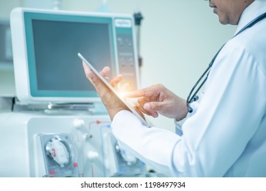 Doctor Holding Medical Records With A Dialysis Machine At Hospital Room