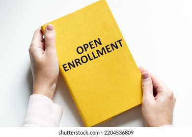 A Doctor Holding A Notebook With The Words Open Enrollment.